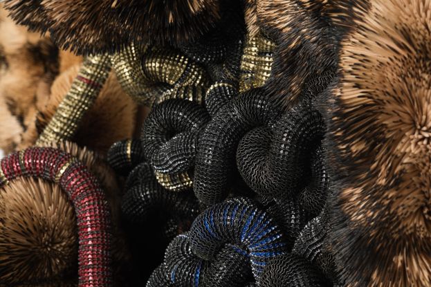 Chimera, 2024, Discarded Beer Bottle Caps threaded onto Electric Fencing Cable, held in Polyurethane Sealant on Board, with Burnt and Unburnt Bamboo and Birch Wood Toothpicks_Photographer_ Matt Slater, Courtesy Pier